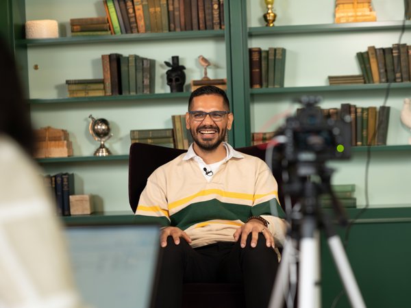 a man sitting in a chair with a camera