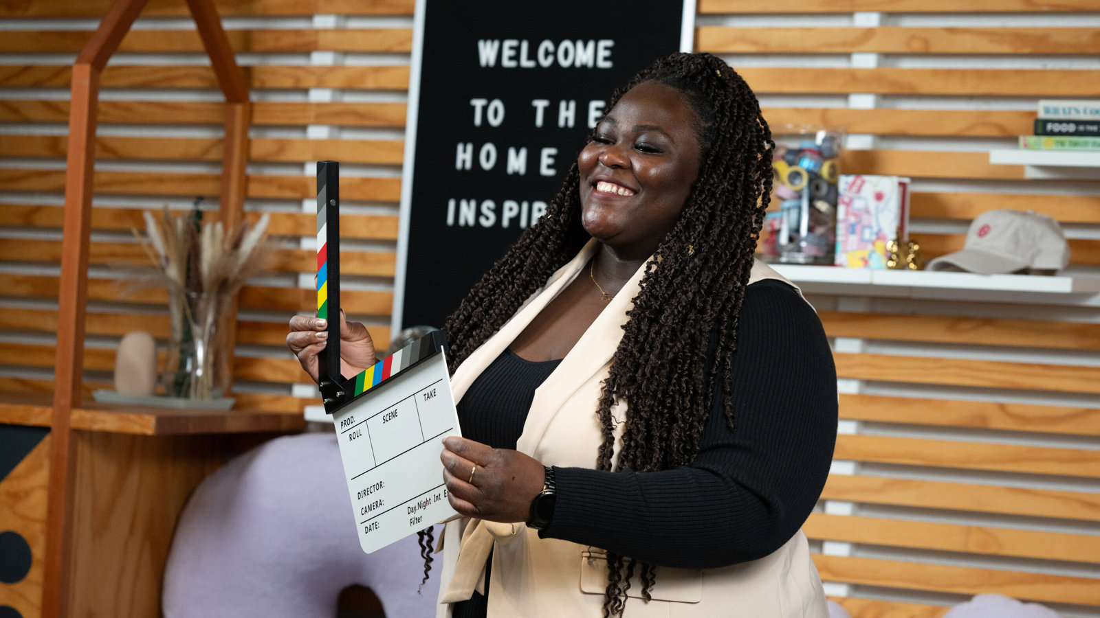 a woman holding a clapper board