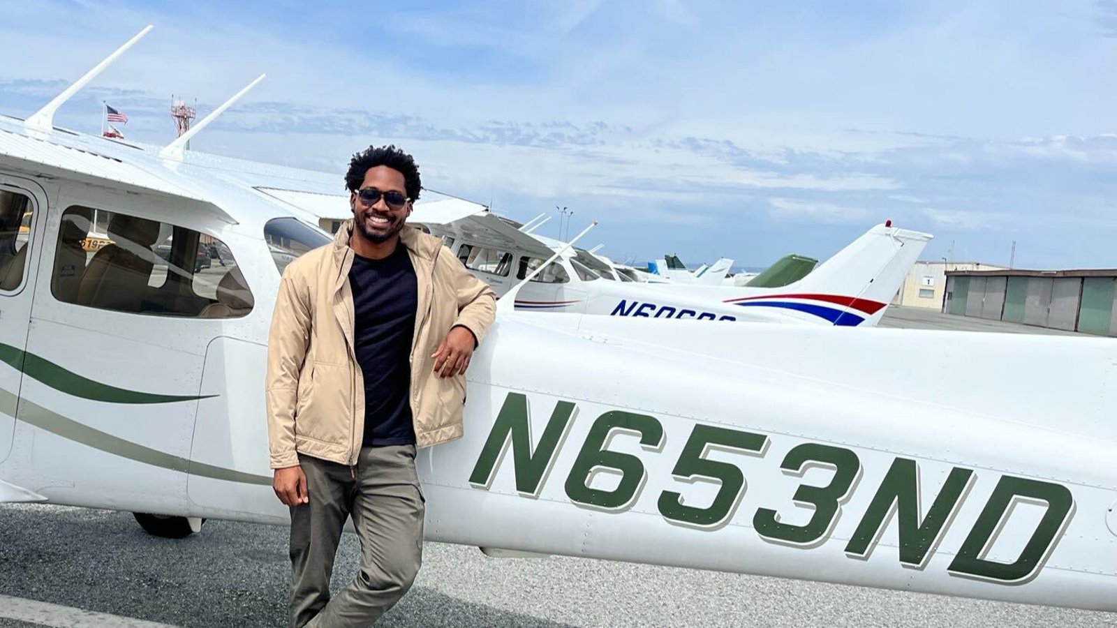 a person standing next to a small plane