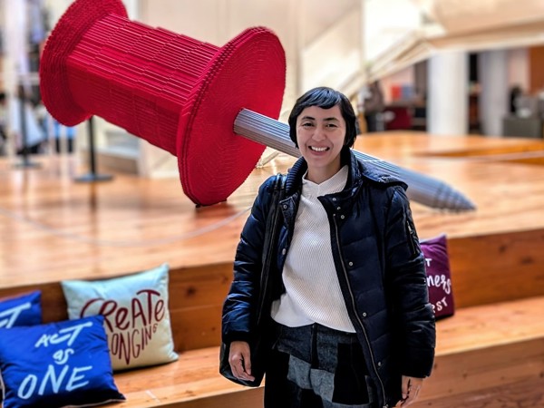 a person standing in front of a large red object