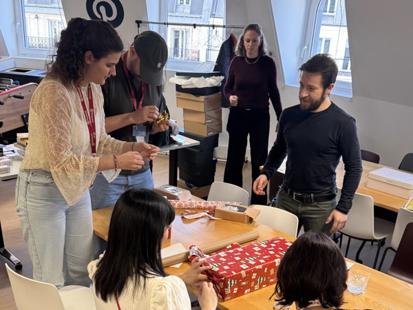 a group of people around a table with presents