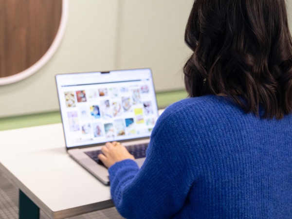 a person sitting at a table using a laptop