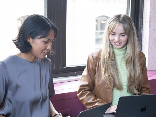 a group of women looking at laptops