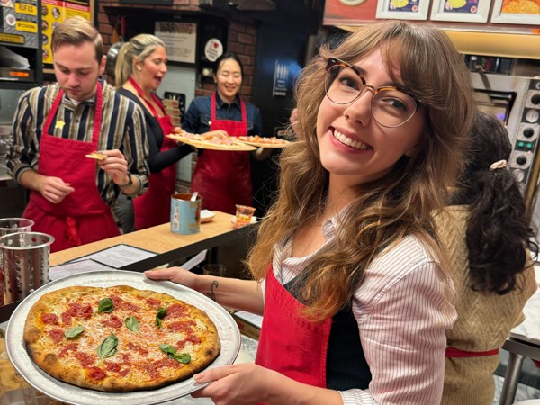 a person holding a pizza