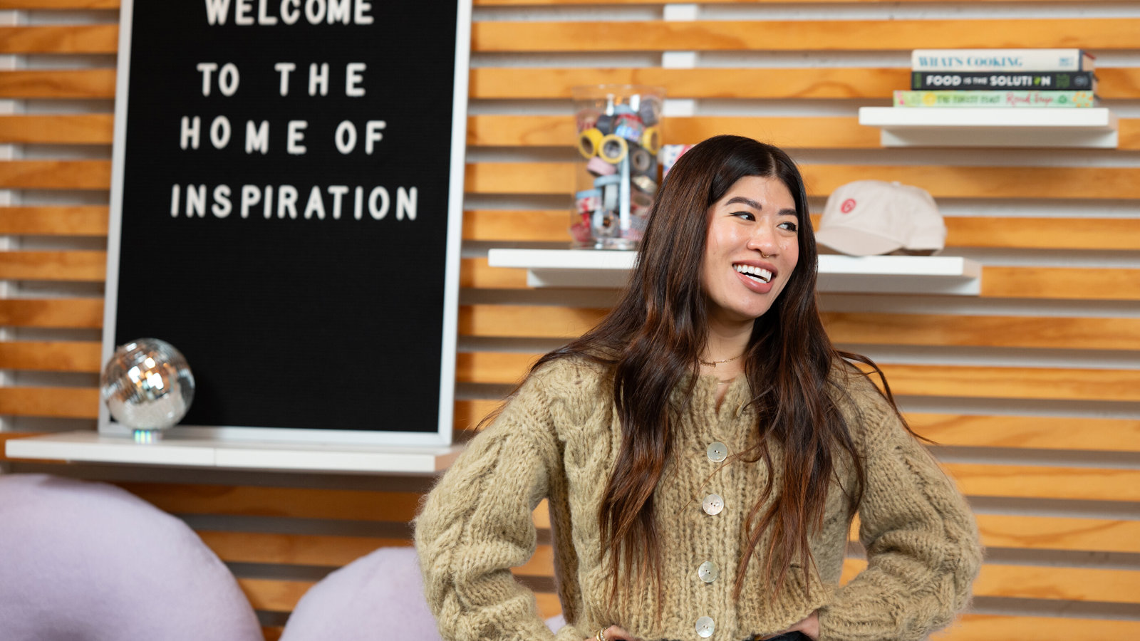 a woman smiling with her hands on her hips