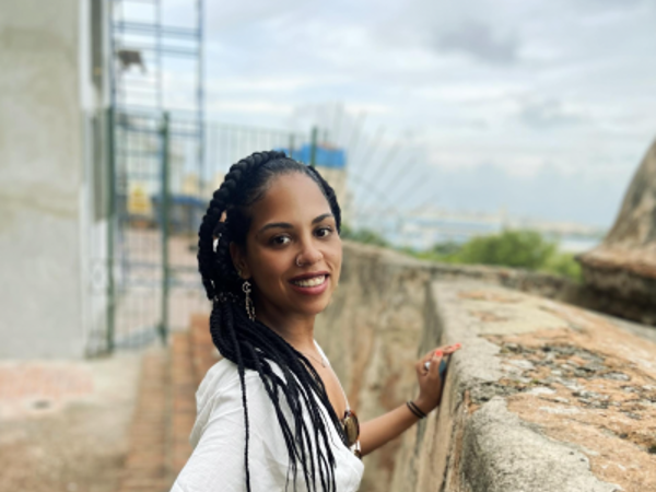a woman with braids smiling at camera