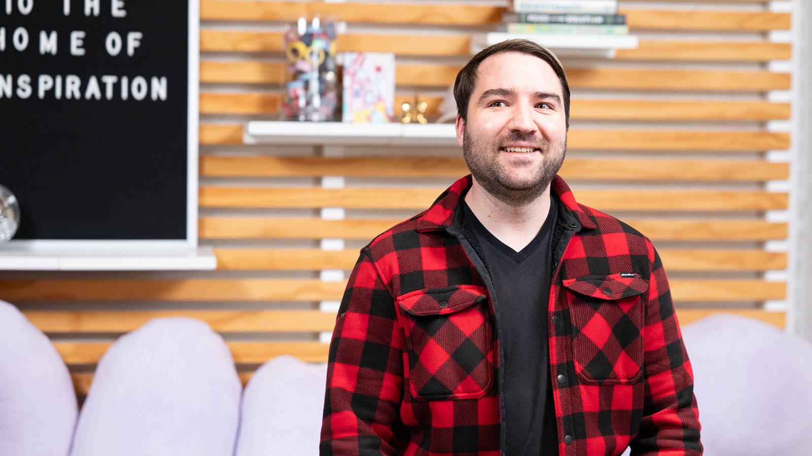 a man in a red and black plaid shirt