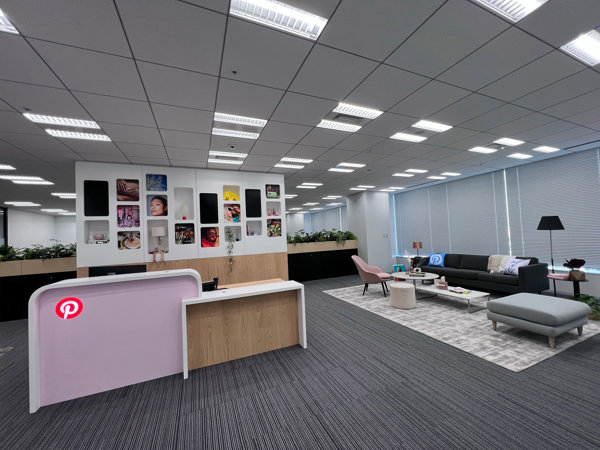 a room with a reception desk and couches