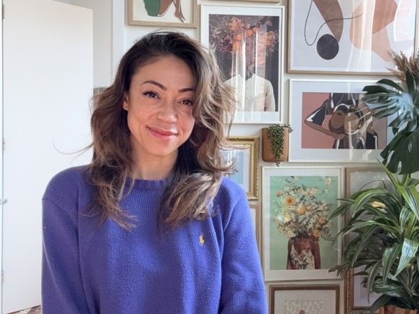 a person standing in front of a wall of art