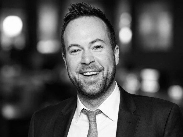 a person in a suit smiling