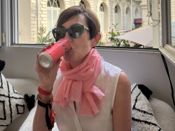 a person drinking from a can