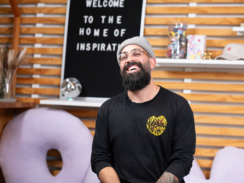 a man in a beanie and a black shirt