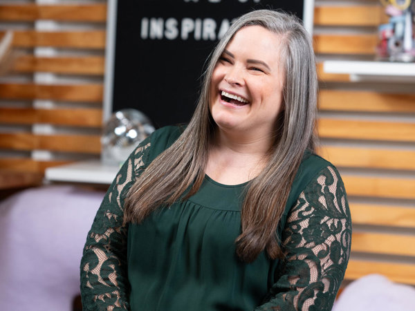 a person laughing in front of a chalkboard