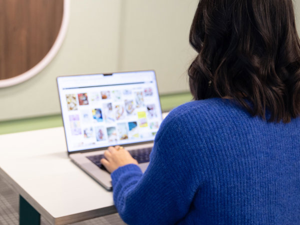 a person sitting at a table using a laptop