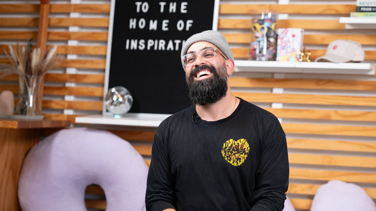 a man in a beanie and a black shirt