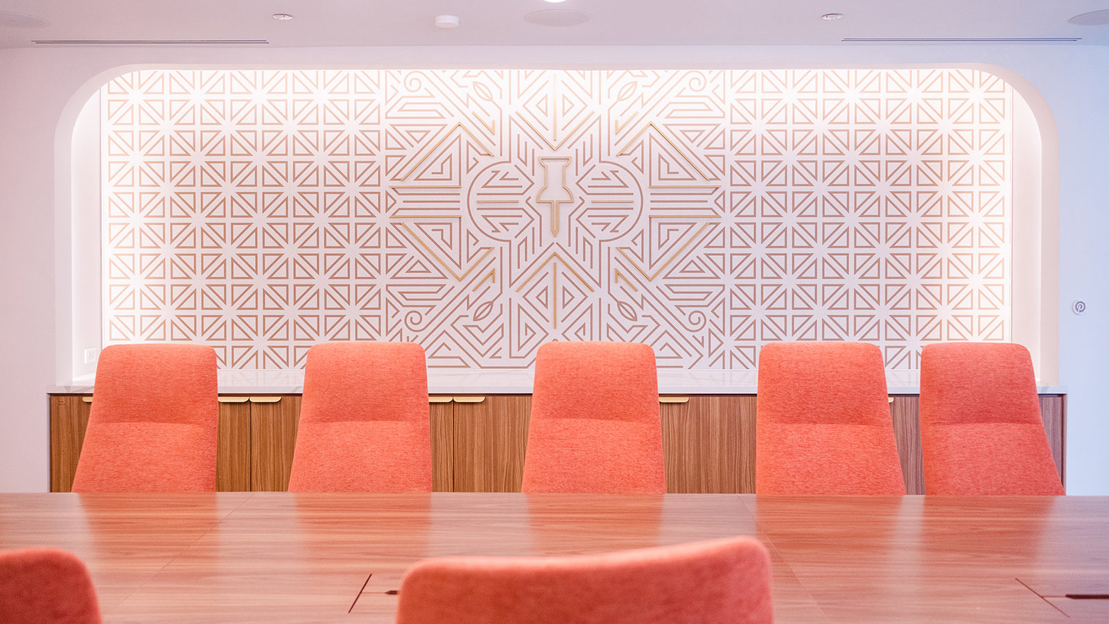 a room with orange chairs and a table