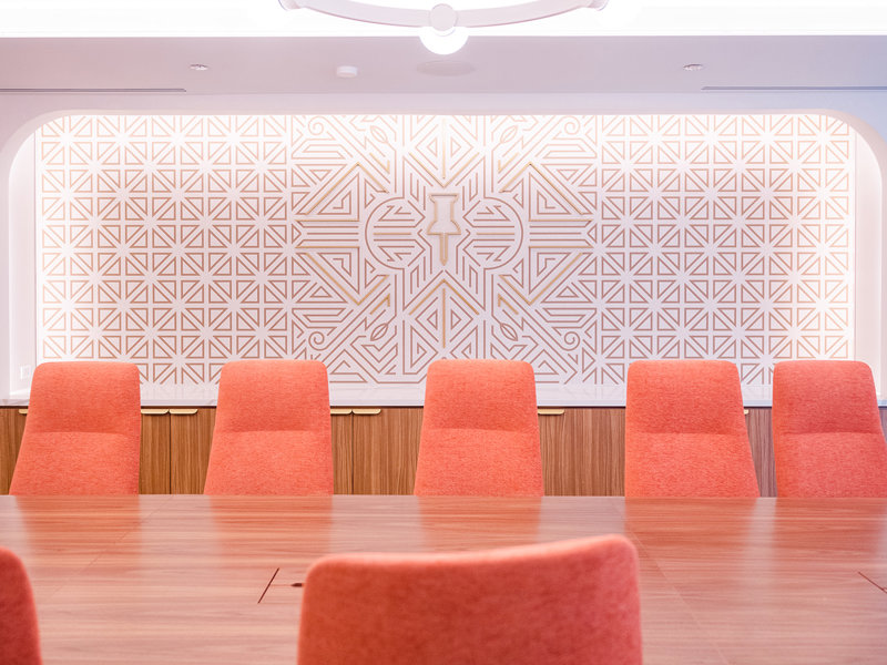 a room with orange chairs and a table