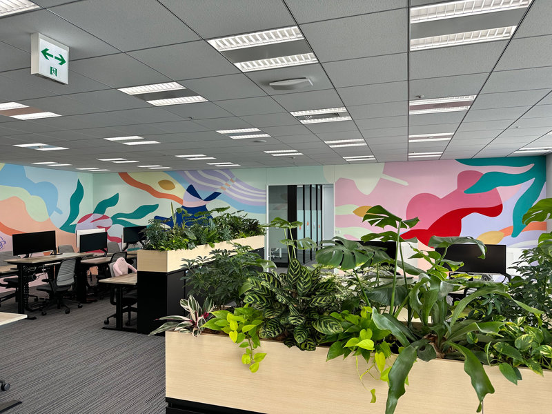 a room with plants and computers