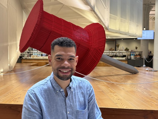 a person sitting in front of a large red object