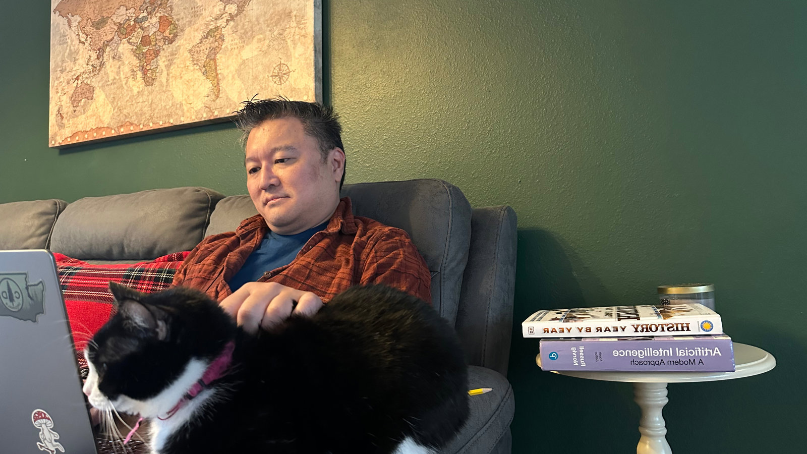 a man sitting on a chair with a cat