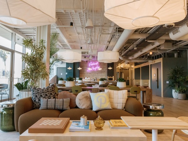 a room with a couch and tables and lamps