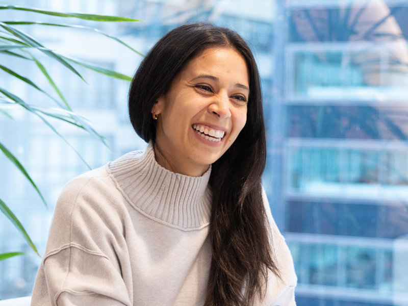 a person smiling at a laptop
