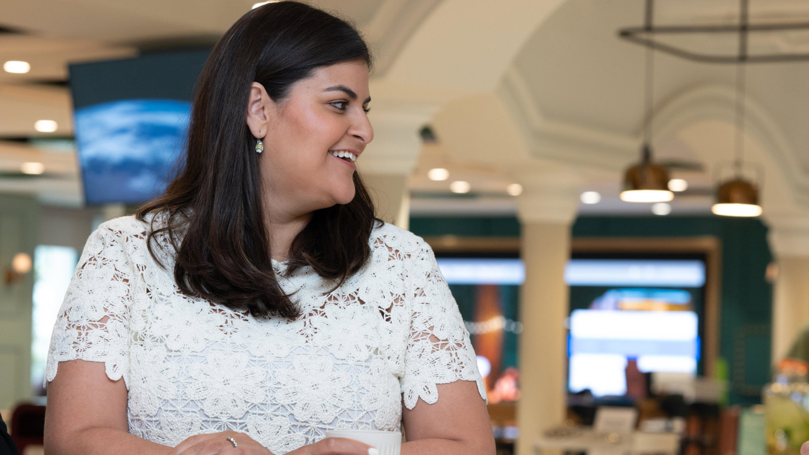 a person smiling at a table