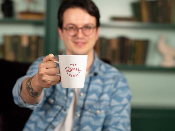 a man holding a white mug