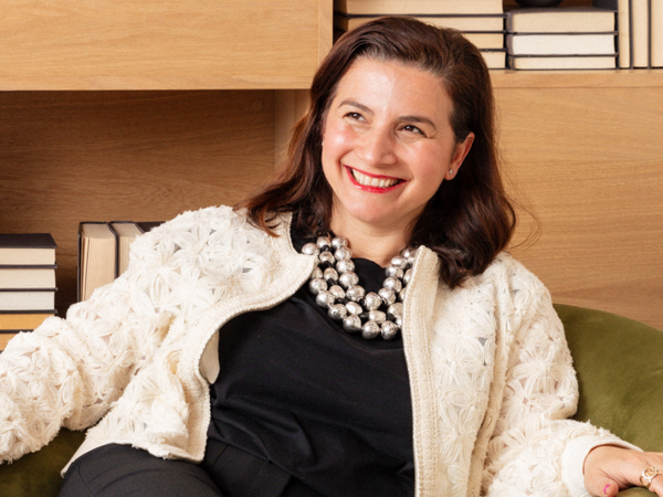 a person smiling and sitting in a chair