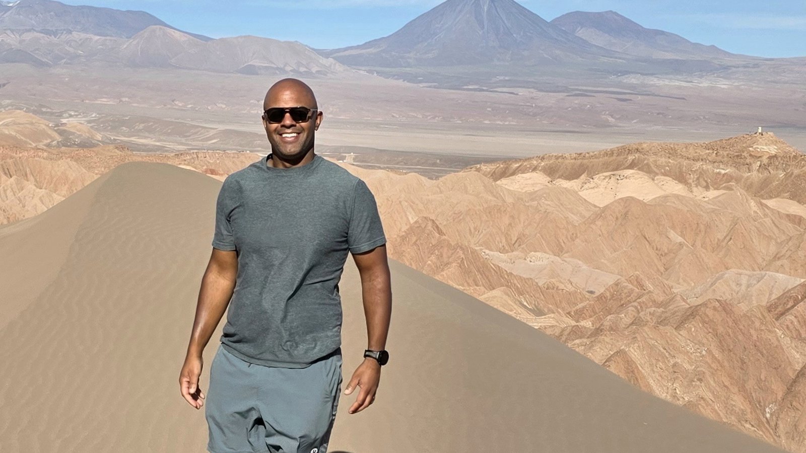 a person standing on a desert dune