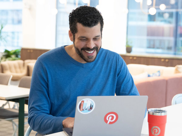 a person sitting at a table with a laptop