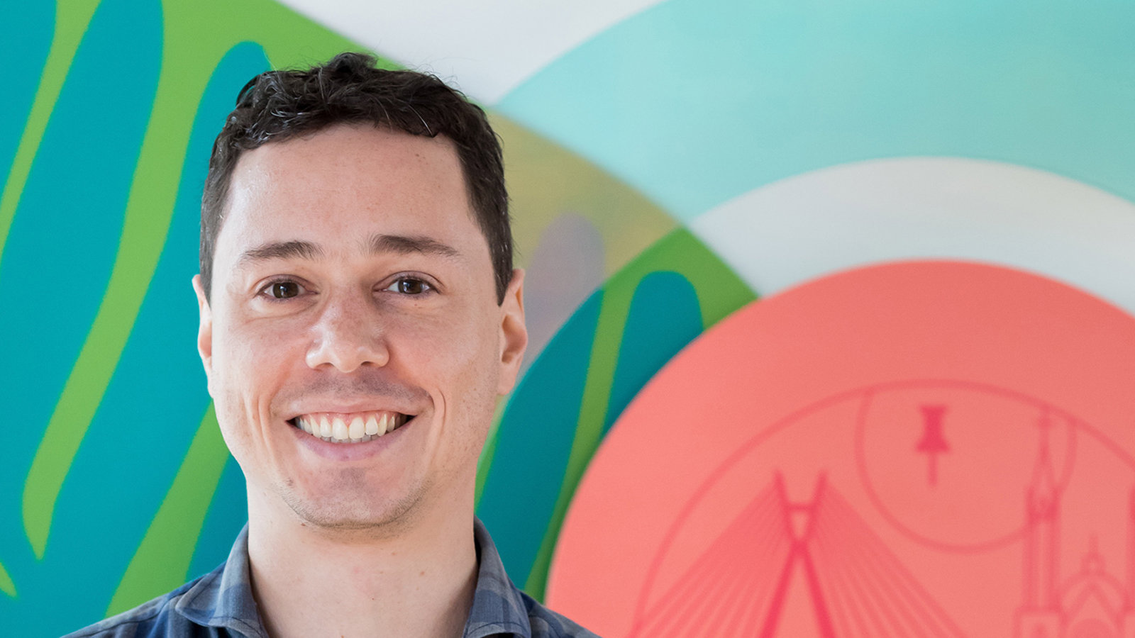 a man standing in front of a colorful wall